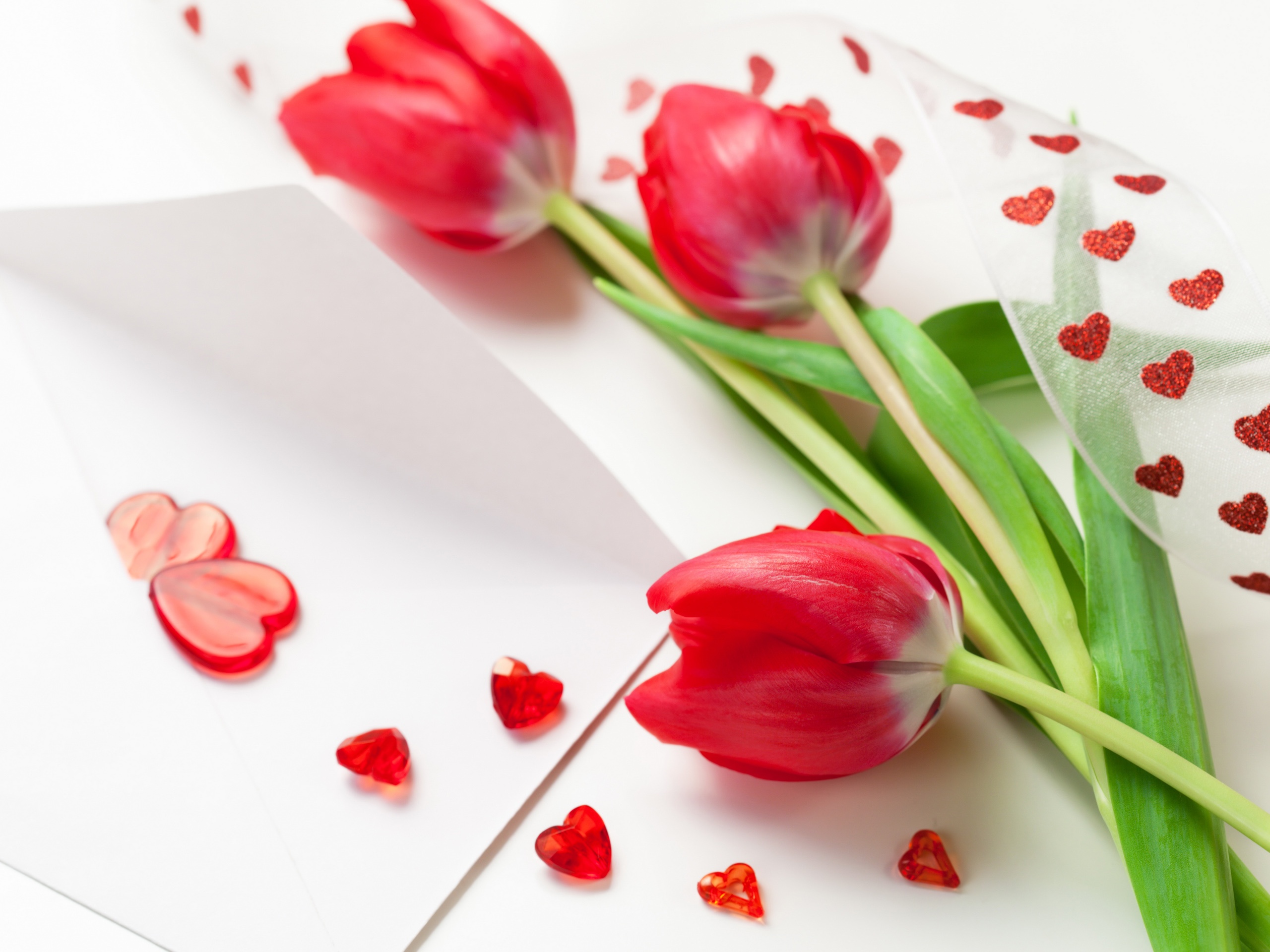 Three-red-tulip-flowers-ribbons-heart-shaped-decoration 2560x1920